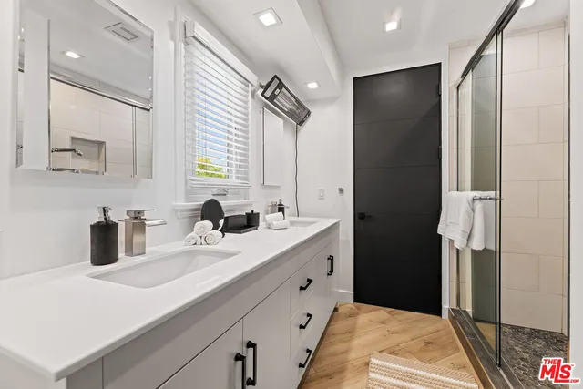 a bathroom with a double vanity sink and a mirror