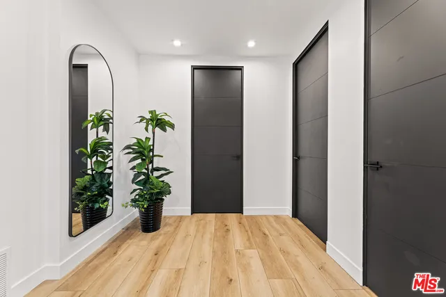 a view of a hallway with wooden door