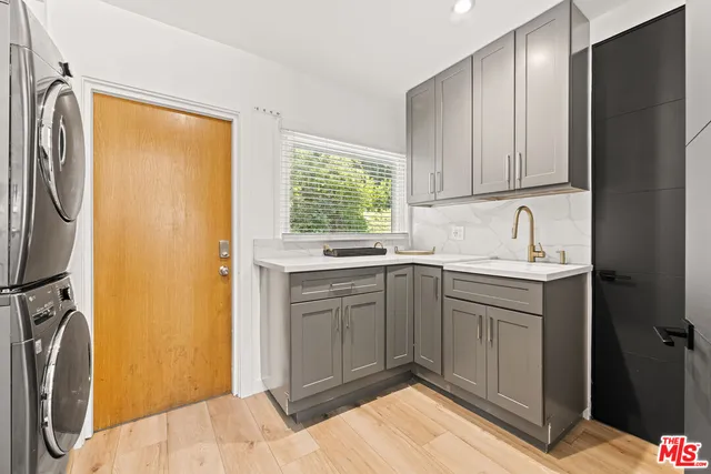 a kitchen with a sink cabinets and a washer dryer
