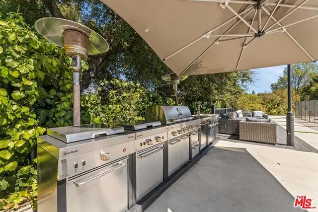 a kitchen with stainless steel appliances granite countertop a sink and a stove