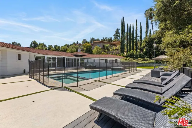 a view of a patio with couches table and chairs and potted plants