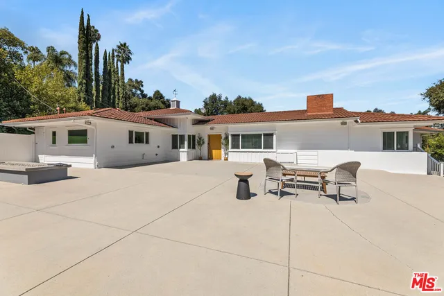 a swimming pool with outdoor seating and yard