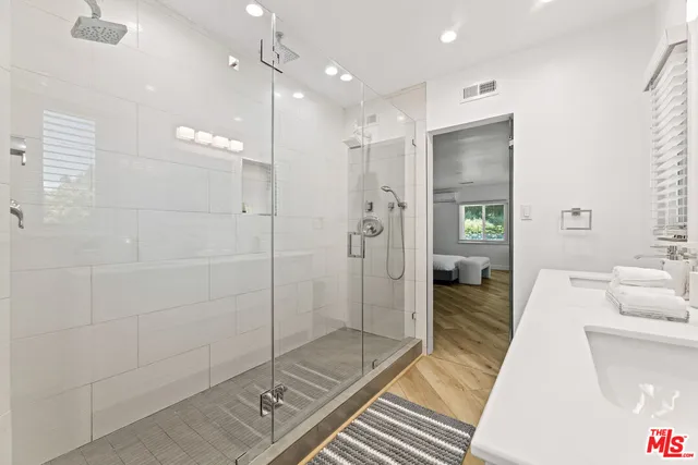 a bathroom with a glass shower door and a bathtub