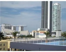 a view of a swimming pool with a patio and plants