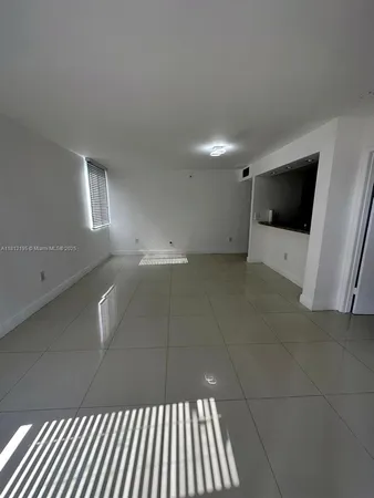 a view of an empty room and a window