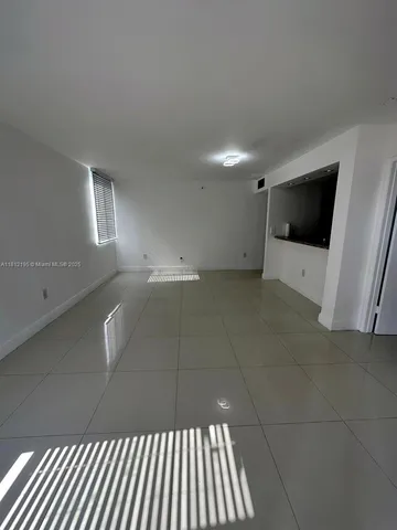 a view of an empty room and a window