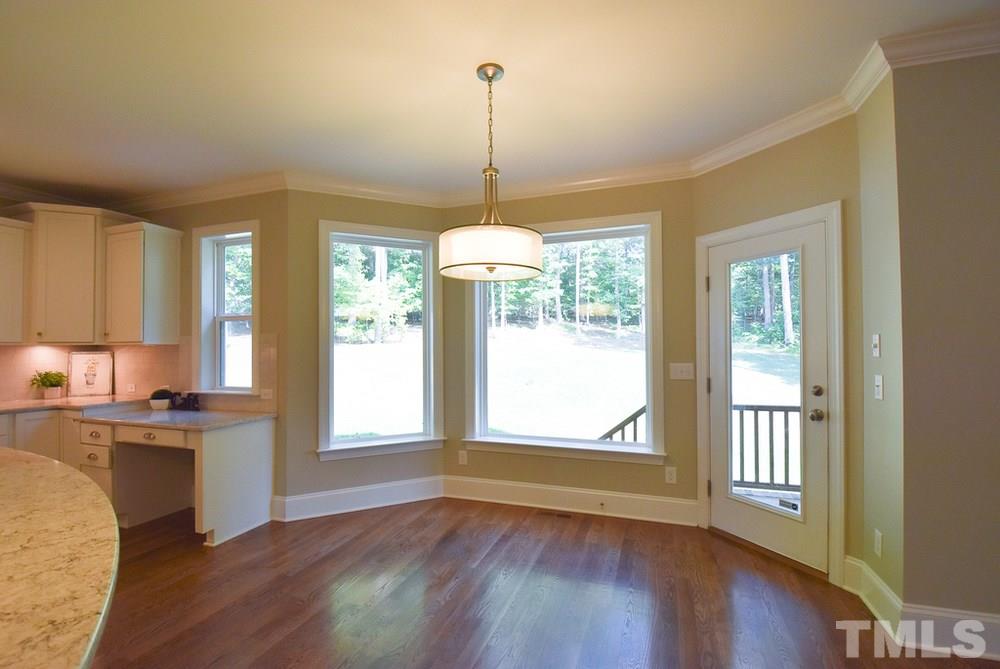2008 Bowling Green Trail Raleigh, NC 27613 - Photo 12 of 30 The bay-windowed Bfast area offers a fabulous light fixture & glass door to the covered Porch; nearby is the Mud Hall from the Garage w/bench/hooks/cubbies.
