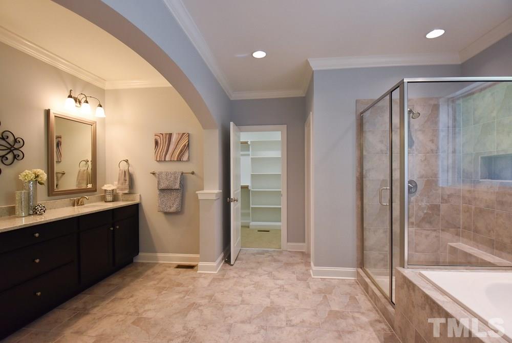 2008 Bowling Green Trail Raleigh, NC 27613 - Photo 20 of 30 The gigantic Master Bath features a long comfort-height granite-topped vanity w/double sinks, tile floor, tiled soaking tub surround, lg tiled shower w/seat, crown molding & private toilet rm.