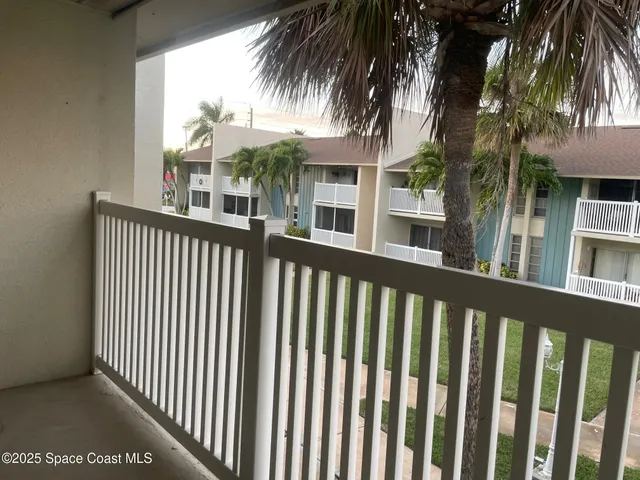 a view of a house with a ocean from a balcony