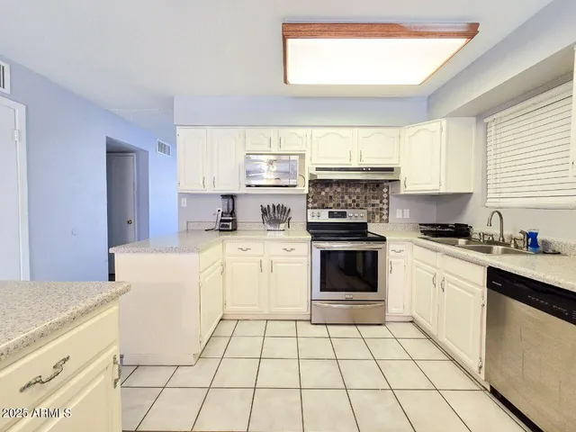 a kitchen with a stove a sink and a refrigerator
