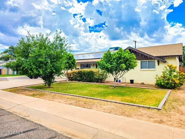 a view of a house with a backyard and a garden