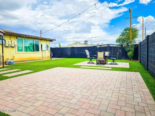 a view of a backyard with sitting area