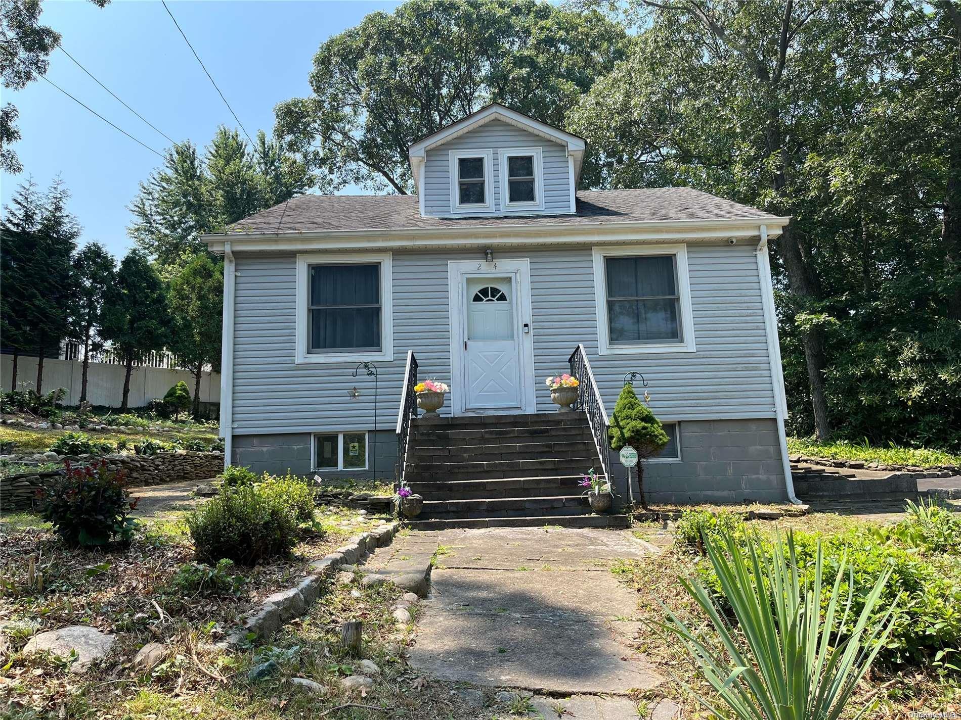24 Tamarack Road Rocky Point, NY 11778 - Photo 1 of 1 a front view of a house with a yard
