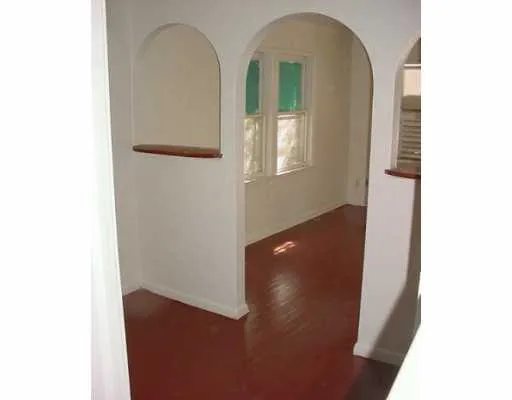 a room with water heater and wooden floor