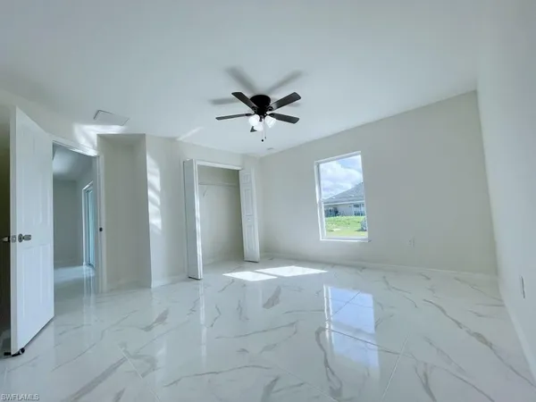 a bathroom with a granite countertop sink a toilet and a mirror