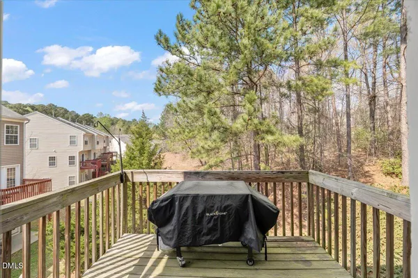 a view of balcony with wooden floor and fence