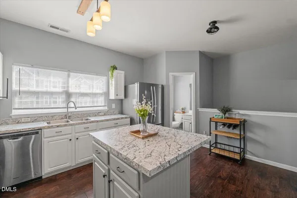 a kitchen with granite countertop a sink and cabinets