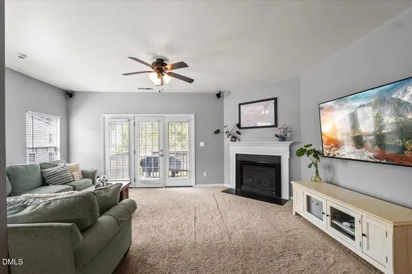 a living room with furniture a flat screen tv and a fireplace