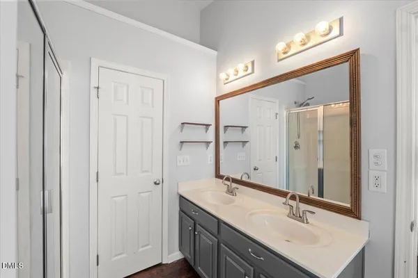 a bathroom with 2 sink and a mirror