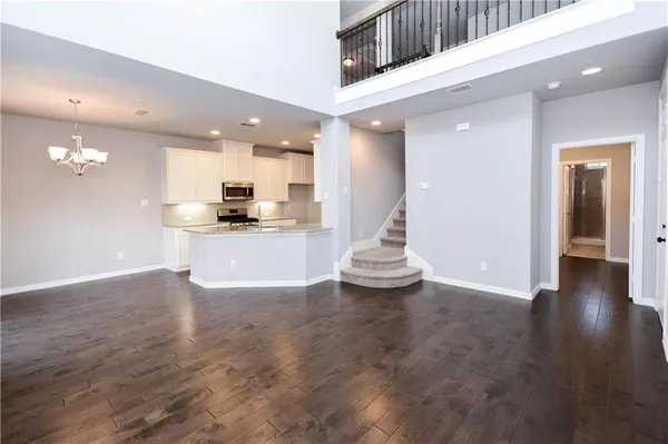 an open kitchen with kitchen island and stainless steel appliances