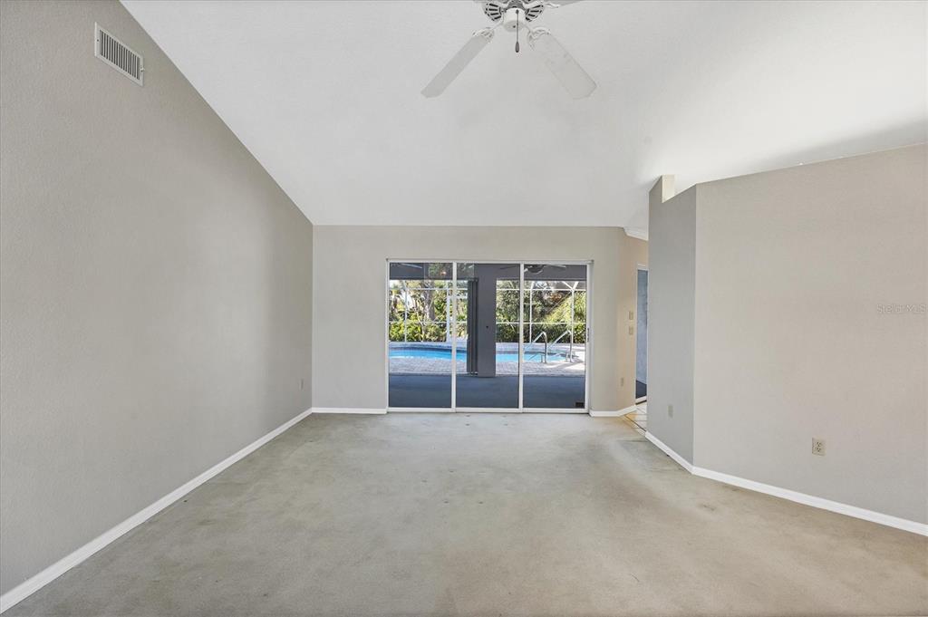 365 Capstan Drive Placida, FL 33946 - Photo 4 of 33 an empty room with windows and chandelier fan