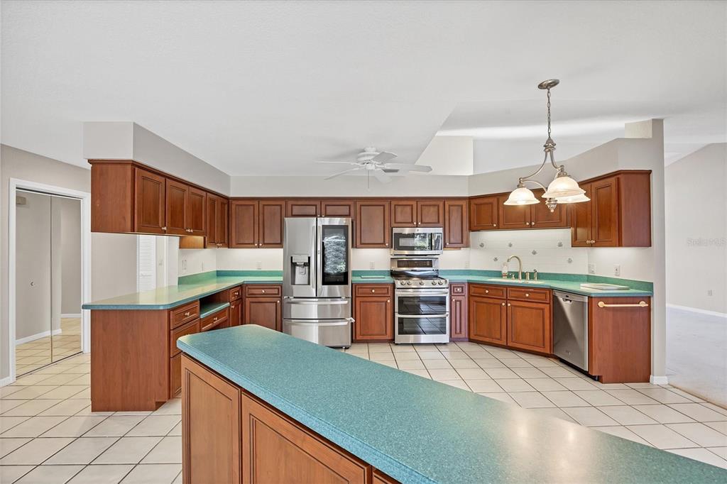 365 Capstan Drive Placida, FL 33946 - Photo 10 of 33 a kitchen with stainless steel appliances kitchen island granite countertop a sink refrigerator and cabinets