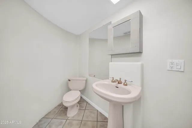 a street view with wooden fence and potted plants