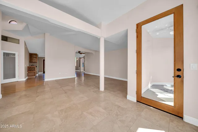 a kitchen with stainless steel appliances granite countertop a stove a sink dishwasher a dining table and chairs with wooden floor