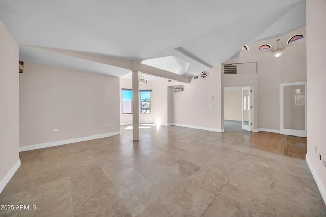 a spacious bedroom with a bed and a couch