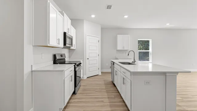 a view of kitchen with granite countertop cabinets and wooden floor