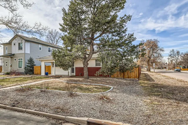 a view of a yard with a house in the background