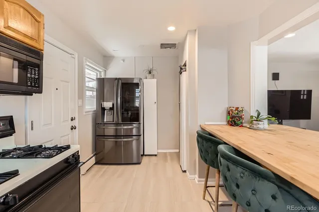 a kitchen with a stove and a refrigerator