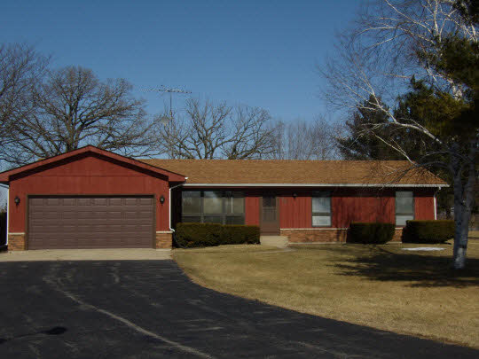 7235 Garden Prairie Road Garden Prairie, IL 61038 - Photo 1 of 11 a front view of a house with a yard and garage