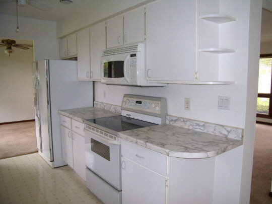 7235 Garden Prairie Road Garden Prairie, IL 61038 - Photo 4 of 11 a kitchen with granite countertop a sink stove and refrigerator