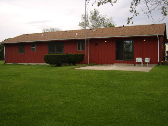 7235 Garden Prairie Road Garden Prairie, IL 61038 - Photo 7 of 11 a backyard of a house with table and chairs