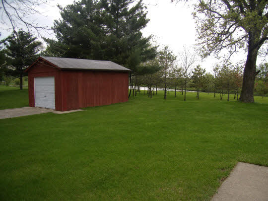 7235 Garden Prairie Road Garden Prairie, IL 61038 - Photo 8 of 11 a backyard of a house with lots of green space