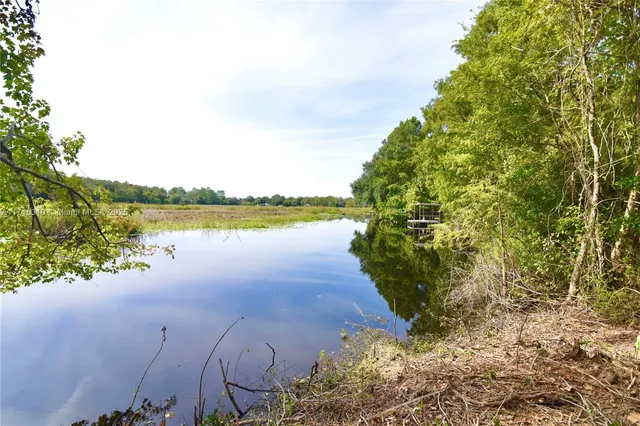 a view of a lake with beach and city view