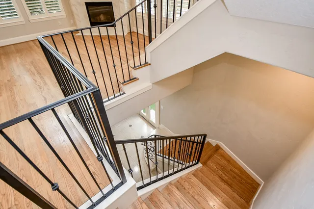 wooden floor in an entryway with staircase and wooden floor
