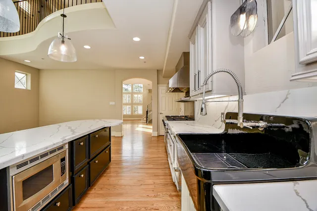 a bathroom with a granite countertop toilet a sink and a mirror