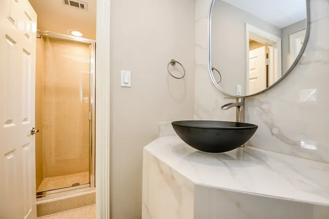 a bathroom with a toilet and a mirror