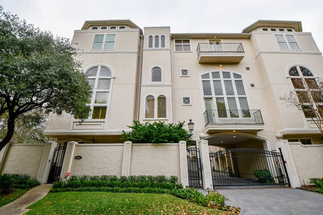 a front view of a residential apartment building with a yard