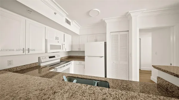 a kitchen with a refrigerator sink and stove