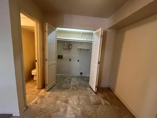 an empty room with an entrance to other room
