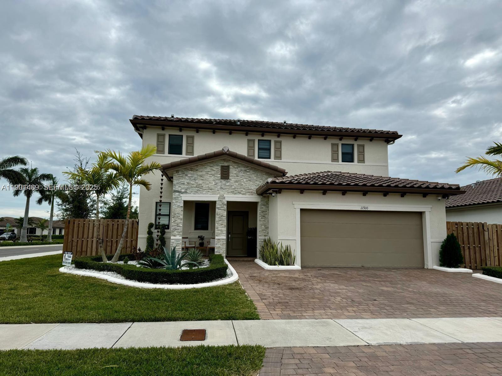 11910 Southwest 243rd Street Homestead, FL 33032 - Photo 1 of 24 a front view of a house with a yard