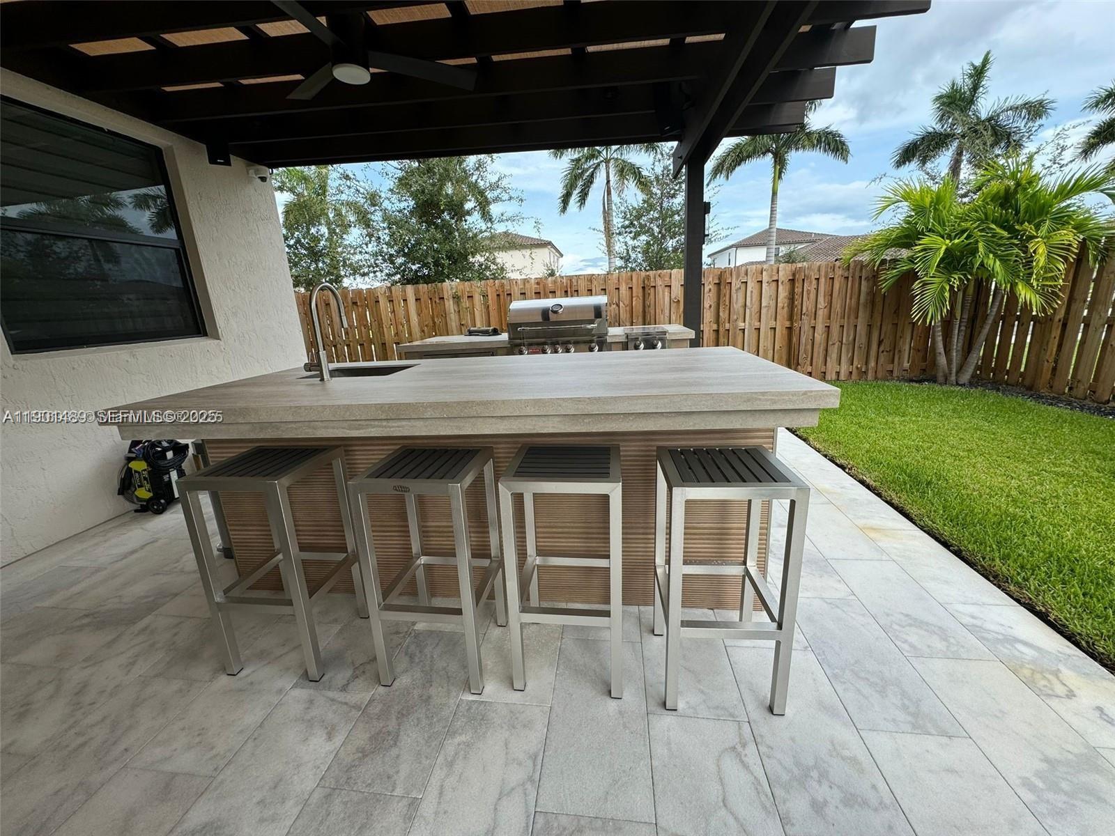 11910 Southwest 243rd Street Homestead, FL 33032 - Photo 11 of 24 a view of a chairs and table in the patio