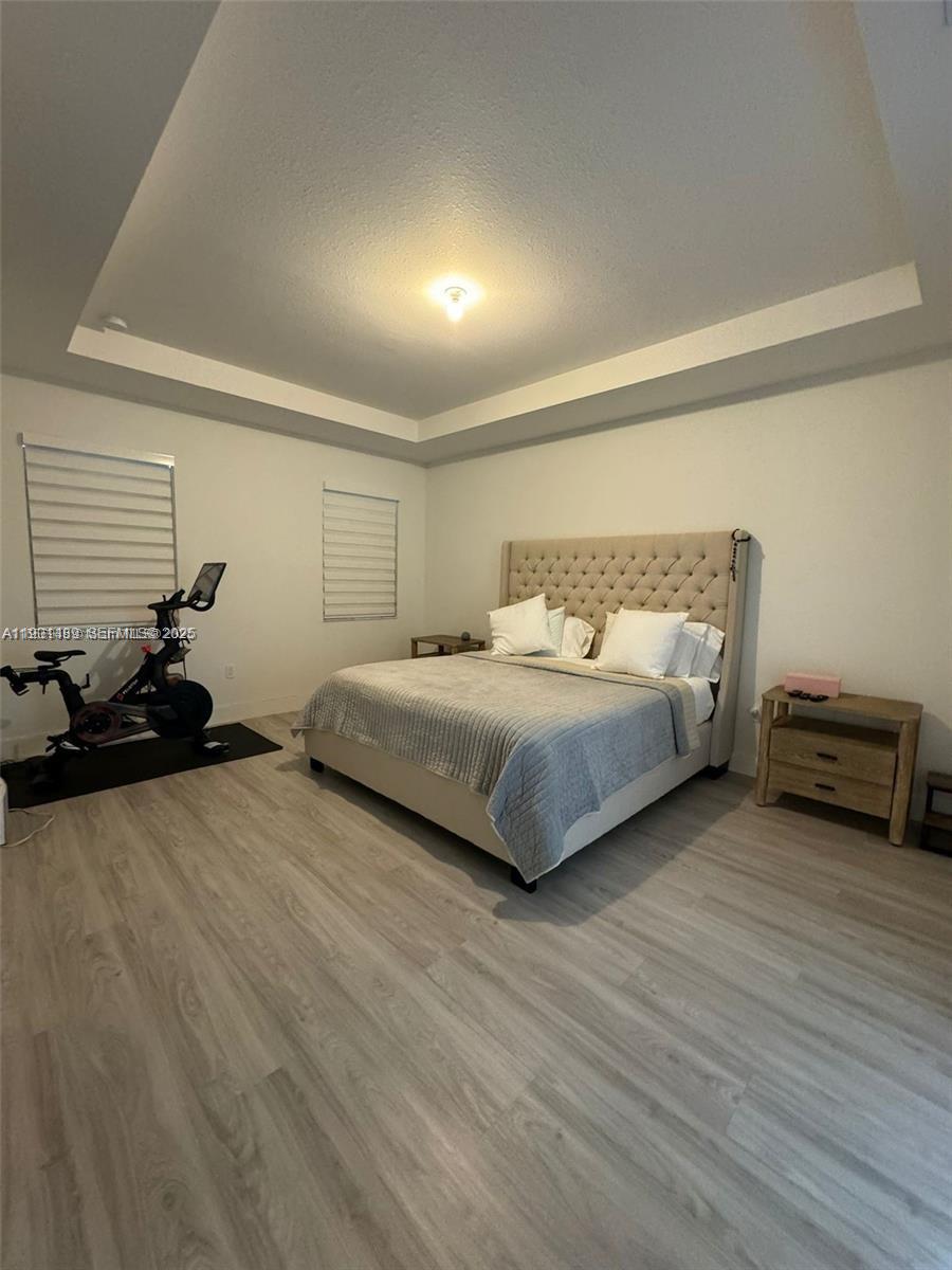 11910 Southwest 243rd Street Homestead, FL 33032 - Photo 14 of 24 a spacious bedroom with a bed and a couch