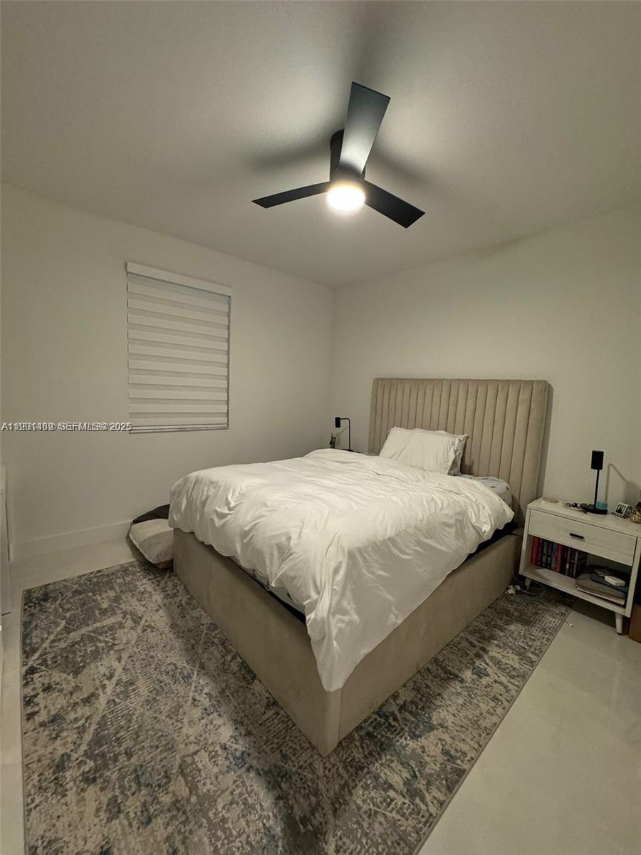 11910 Southwest 243rd Street Homestead, FL 33032 - Photo 15 of 24 a bedroom with a bed and ceiling fan