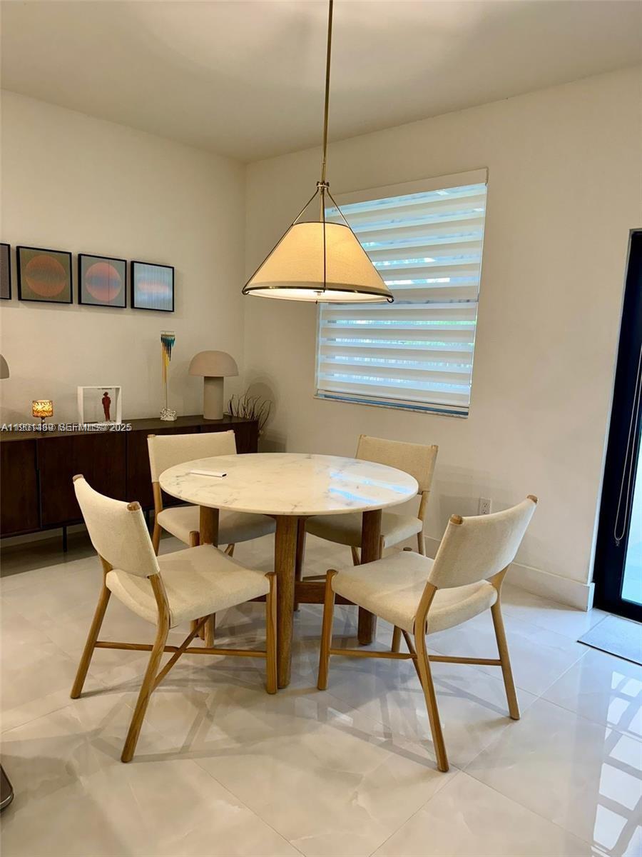 11910 Southwest 243rd Street Homestead, FL 33032 - Photo 17 of 24 a dining room table in a room