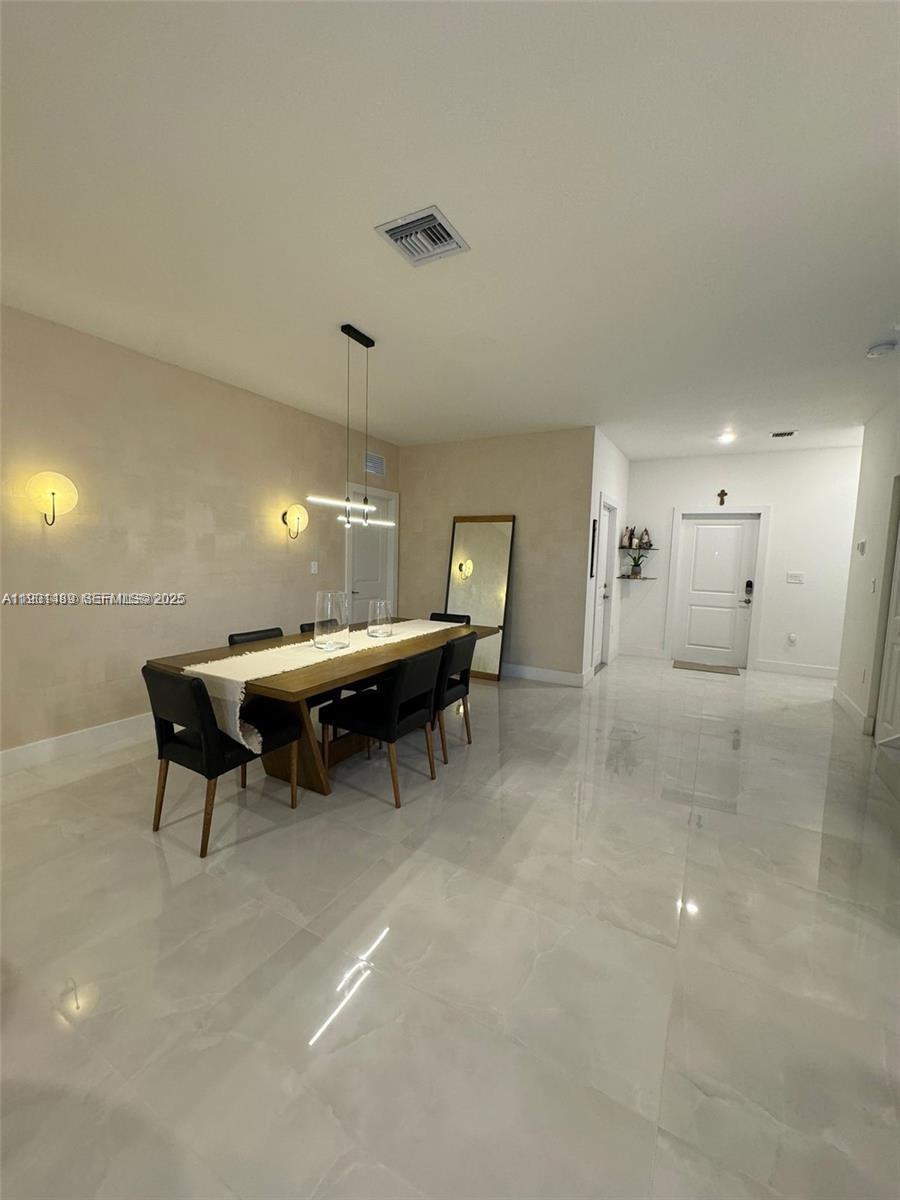 11910 Southwest 243rd Street Homestead, FL 33032 - Photo 18 of 24 a living room with furniture and a chandelier
