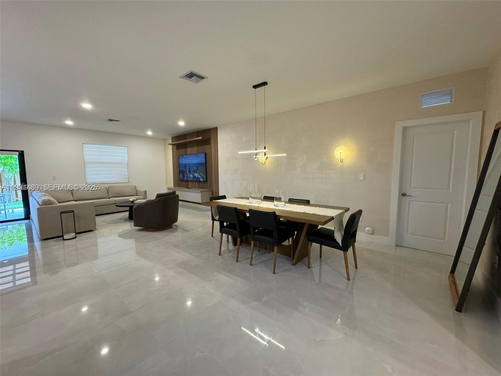 11910 Southwest 243rd Street Homestead, FL 33032 - Photo 19 of 24 a open kitchen with a table and chairs